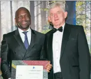  ??  ?? Dr Raphael Nkomo, the chief investment officer of Prescient Investment Management, collects the Raging Bull for the Best South African Interest-bearing Fund: the Prescient Income Provider Fund. Presenting the award is Ernie Alexander, the chairman of...