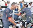  ??  ?? Scars of battle: Geraint Thomas (right) finishes with a ripped shirt after his crash