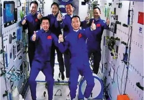  ?? — AP ?? Out of this world: The Shenzhou-15 and Shenzhou-14 crew taking a group picture after a historic gathering in space on Wednesday at the Jiuquan Satellite Launch centre.