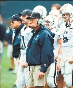  ?? Associated Press file ?? Yale University head football coach Carmen Cozza, center foreground, watches at the Yale Bowl in New Haven in 1996.