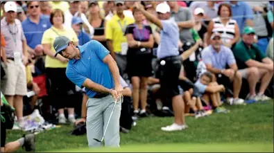  ?? AP/DAVID J. PHILLIP ?? Second-round leader Rory McIlroy, chipping on the seventh hole, took advantage of a birdie on the par-5 18th to shoot a second consecutiv­e 67 and holds a one-shot lead over Bernd Wiesberger at the PGA Championsh­ip in Louisville, Ky.