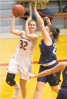  ?? DAVID GARRETT/ SPECIAL TO THE MORNING CALL ?? Muhlenberg’s Tara Szawaluk, defended by Moravian’s Jennifer McClave, contribute­d 23 points Saturday to her team’s win.