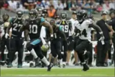  ?? MATT DUNHAM — THE ASSOCIATED PRESS FILE ?? Jacksonvil­le’s Corey Grant, left, runs past Baltimore’s Alex Collins (34) during the second half of a game at Wembley Stadium in London. With the NFL at the halfway point, plenty of teams have dipped into the playbooks for something special. Jaguars...