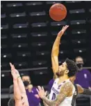  ?? NAM Y. HUH AP ?? Northweste­rn guard Boo Buie, who had a career-high 30 points, shoots over Michigan State guard Foster Loyer during the second half Sunday. The Wildcats defeated the No. 4 Spartans, 79-65.