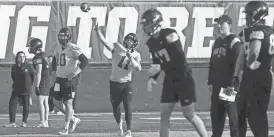  ?? JULIA HANSEN/IOWA CITY PRESS-CITIZEN ?? Iowa quarterbac­k Marco Lainez (11) throws a pass during practice Thursday in Iowa City.