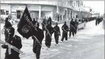  ?? Associated Press ?? This undated file image posted on a militant website on Jan. 14, 2014, shows fighters from the al-Qaida linked Islamic State of Iraq and the Levant (ISIL), now called the Islamic State group, marching in Raqqa, Syria.
