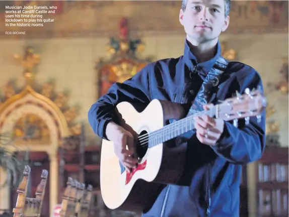  ?? ROB BROWNE ?? Musician Jodie Daniels, who works at Cardiff Castle and uses his time during lockdown to play his guitar in the historic rooms