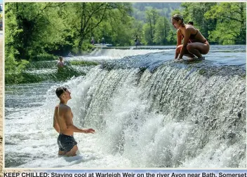  ??  ?? KEEP CHILLED: Staying cool at Warleigh Weir on the river Avon near Bath, Somerset