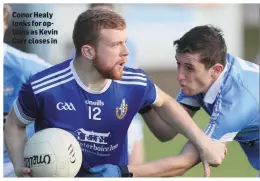  ??  ?? Conor Healy looks for options as Kevin Carr closes in