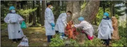  ??  ?? Health care workers administer a dose of Covishield vaccine to Basheera Banoo, a Kashmiri shepherd woman, on June 22 during a covid-19 vaccinatio­n drive in the forest area of Gund.