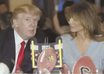  ?? AP PHOTO ?? LOOKING FOR A TOUCHDOWN: President Trump and first lady Melania Trump watch the Super Bowl at a party at Trump Internatio­nal Golf Club in West Palm Beach, Fla., last night.