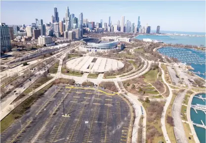  ?? BRIAN ERNST/SUN-TIMES FILE PHOTO ?? The area south of Soldier Field includes a parking lot and garage. The Bears are looking at that land as the potential site of a new lakefront domed stadium.