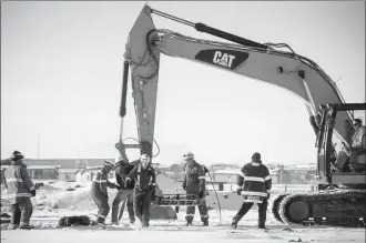  ?? Herald photo by Tijana Martin @TMartinHer­ald. ?? Emergency service personnel were forced to use their skills on Monday afternoon during a mission to rescue a injured man from an undergroun­d workplace along the 4400 block of 43 Street North.