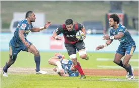  ??  ?? The Crusaders’ Pete Samu runs between the Brumbies’ Tevita Kuridrani, left, and Henry Speight.