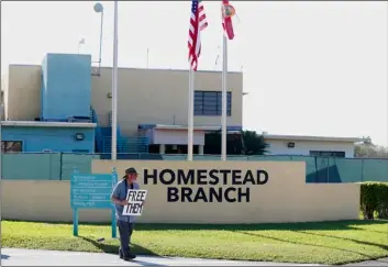  ??  ?? In this Feb. 19 file photo, Josh Rubin demonstrat­es in front of the Homestead Temporary Shelter for Unaccompan­ied Children, in Homestead, Fla.
AP Photo/WIlfredo lee