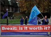  ?? AP/MATT DUNHAM ?? An anti-Brexit supporter holds a European flag Thursday by a banner across the street from the Houses of Parliament in London, Thursday.