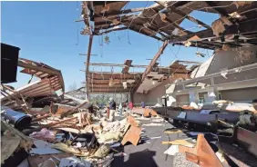  ?? ROGELIO V. SOLIS/AP ?? Broken lumber, loose paneling, insulation and destroyed pews are all that remain of the First Pentecosta­l Church in Columbus, Miss., on Sunday after the area was struck by a tornado.