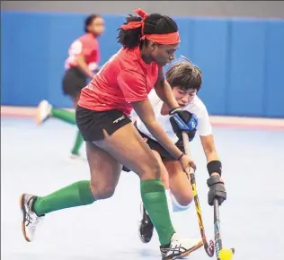  ??  ?? Guyana’s Makeda Harding (left) trying to keep possession against Canada’s Alison Lee during their clash in the 2021 Indoor Pan Am Cup (IPAC) yesterday in the USA.
