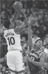  ?? RICK MADONIK, TORONTO STAR ?? Toronto Raptors guard DeMar DeRozan throws up another three on his way to 52 points Monday night.