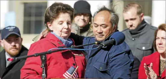  ?? RICK KAUFFMAN — DIGITAL FIRST MEDIA ?? Maureen Robinson, left, a former captain in the Army Nurse Corps, embraces her son, Mark Robinson, right, a child born among the Montagnard­s, a group of Vietnamese who were said to be among the greatest allies the United States had in the Vietnam War.