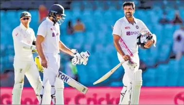  ?? AP ?? Not-out batsman Ravichandr­an Ashwin and Hanuma Vihari walk from the field following play on the final day of the third Test between India and Australia at the Sydney Cricket Ground on Monday. The Test ended in a draw and the series is at 1-1 all with one test to play.