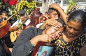  ?? ASSOCIATED PRESS FILE PHOTO ?? Shirley Palencia weeps during the burial service for her 17-year-old sister Kimberly Palencia Ortiz, who died in the Virgen de la Asunción Safe Home fire. Authoritie­s said the March 8 fire that swept through parts of the institutio­n when mattresses...