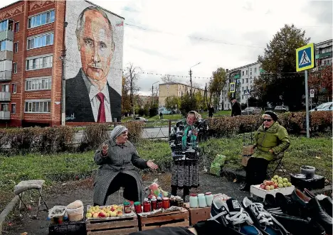  ?? PHOTO: REUTERS ?? While Vladimir Putin’s friends and family have become wealthy under his rule, life continues as ever for most Russians. Here, elderly women wait for customers as they sell their self-made food products at a street market outside Moscow.