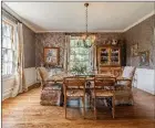  ?? ?? An antique chandelier and ample natural light add charm to the dining room.