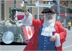  ??  ?? The town crier rings a bell at the beginning of the annual Welland Rose Festival Grande Parade Sunday afternoon.