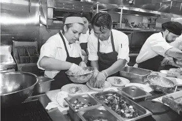  ?? JOHNNY LOUIS/GETTY IMAGES FILE ?? Chefs Amanda Freitag and Peter Boulukos prepare Dinner On Fort Lauderdale Beach during the 2015 event.