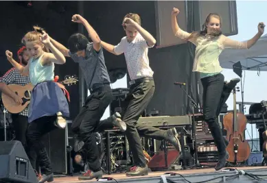  ?? PAT MARCHEN/ SPECIAL TO THE EXAMINER ?? Next Generation Leahy members Cecilia, 10, Angus, 12, Gregory, 13 and Adele Leahy, 15, wowed the crowd at the Greenbridg­e Celtic Folkfest on Friday with music and fancy footwork. The children of Doug and Jennifer Leahy were joined on the stage by...