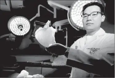  ?? AP/Houston Chronicle/MELISSA PHILLIP ?? Earlier this month, Dr. C. Huie Lin, a specialist in adult congenital and interventi­onal cardiology, displays a 3-D printed model of a patient’s heart at Houston Methodist Research Institute.