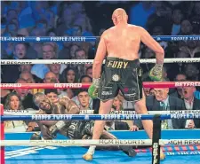  ??  ?? Tyson Fury sends Deontay Wilder to the canvas.