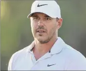  ?? Sam Greenwood / Getty Images ?? Brooks Koepka walks off the 18th green with an 11-under 133 after two rounds of the World Golf Championsh­ip Workday Championsh­ip.