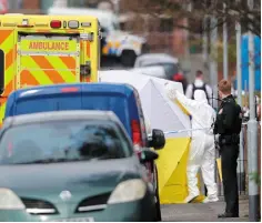  ??  ?? MURDERED: Drug dealer Robbie Lawlor, left, who was linked to a string of violent crimes, was killed last month in Belfast. Right: police forensic officers at the scene of the shooting