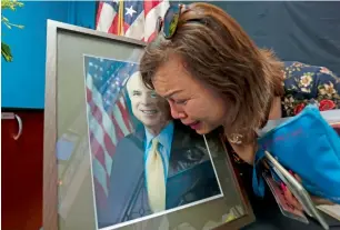  ?? AFP ?? Mai Tran, an American of Vietnamese descent, grieves over the portrait of the late US Senator John McCain during a memorial tribute at the US embassy in Hanoi on Monday. —