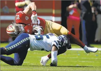  ?? Lachlan Cunningham Associated Press ?? NINERS TIGHT END George Kittle (85) is tackled by Seahawks linebacker Jordyn Brooks last Sunday. Kittle will be sidelined for the next three games and is eligible to return Nov. 7.