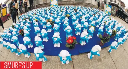  ?? Reuters ?? Smurf dolls promote the new 3D computer-animated movie Die Schluempfe – Das verlorene Dorf (The Smurfs – The lost village) in front of Stadelhof railway station in Zurich, Switzerlan­d, yesterday.Picture: