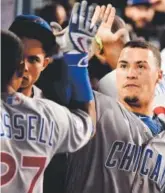  ?? Getty Images ?? Javier Baez, right, congratula­tes Addison Russell on his home run in the sixth inning.