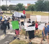  ??  ?? Hundreds of citizens turned out in Mentor to silently march in protest of police brutality, culminatin­g a weeklong collective activism addressing racial injustice.