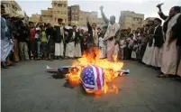  ?? (Khaled Abdullah/Reuters) ?? PROTESTERS LOYAL to the Shi’ite Houthi rebel group burn an effigy of a US aircraft during a 2013 demonstrat­ion in Sanaa.