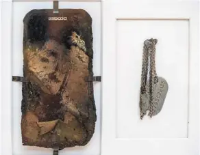  ?? War Diaries ?? The burnt mobile phone and military identifica­tion tag of Ivanna Rumiantsev­a’s father Illich, who are part of her e-diary, are displayed at the exhibition.