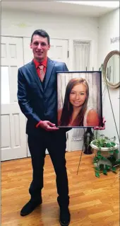  ?? Courtesy photo ?? Boyfriend Jesse Gardner Jr. holds a photo of Tommi Miller at Mena’s home before heading to Chico State University to receive FFA degree on behalf of Miller.