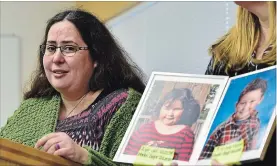  ?? FRANK GUNN THE CANADIAN PRESS ?? Jennifer Neville-Lake speaks to media as a supporter holds a photo of her late daughter Milly, left, and son Daniel.