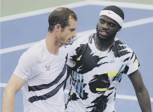  ??  ?? 0 Andy Murray chats to Frances Tiafoe at the net after the Scot defeated the American 7-6 (6), 3-6, 6-1 at the Western & Southern Open.