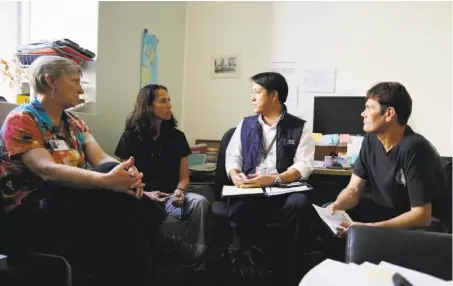  ?? Lea Suzuki / The Chronicle ?? Dr. Clement Yeh (second from right), the medical director for the Fire Department and the 911 dispatch system, meets with staff.