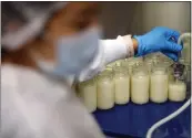  ?? ARIC CRABB STAFF ARCHIVES ?? Haeran Lee fills bottles with milk at Mothers' Milk Bank in San Jose on July 13. The milk bank has been in operation since 1974.