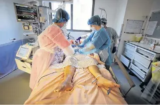  ?? REUTERS/ERIC GAILLARD ?? Medical staff in Canada and around the world, including these at a hospital in France, often deal with excruciati­ng experience­s when trying to help those critically ill with COVID-19.