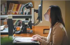  ?? FENG KAIHUA / XINHUA ?? Wang Yufeng, who is visually impaired, reads with the help of a machine at a rehabilita­tion center in Yinchuan, Ningxia Hui autonomous region, last month.