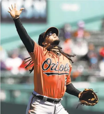  ?? MICHAEL DWYER/AP ?? Orioles shortstop Freddy Galvis signals for the catch during the first inning of Saturday’s victory over the Red Sox at Fenway Park. The Orioles won 4-2, giving them a chance for a season-opening sweep.